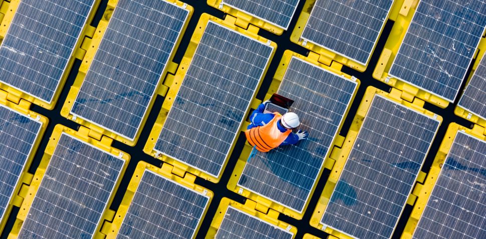 Floating solar panels providing renewable energy. Aerial view floating on solar cells and