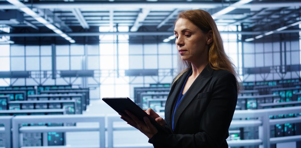 Woman working in data center housing advanced data storage infrastructure